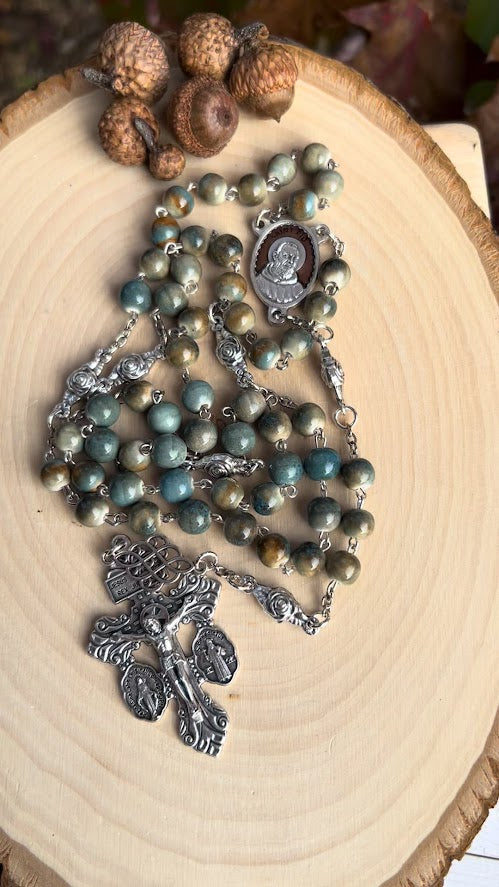 Artisan Catholic rosary with glazed ceramic beads, Padre Pio medal centerpiece, and Pardon Crucifix engraved with ‘Jesus Nazarenus Rex Judaeorum.’