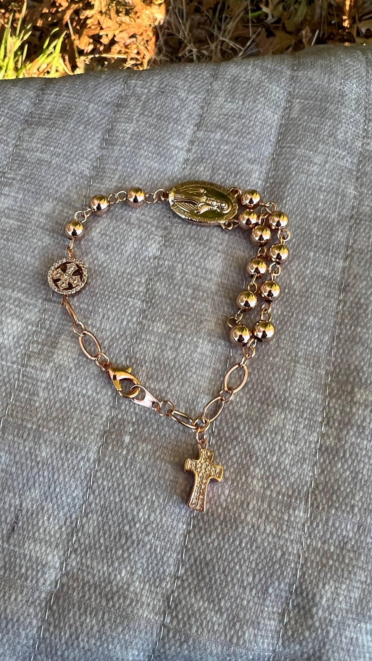 Elegant rosary bracelet for prayer and devotion, handcrafted in rose gold with religious charms