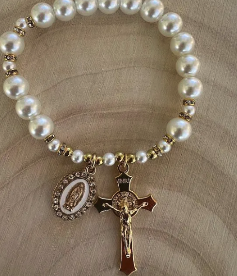 Stretch rosary bracelet with white pearls, gold rhinestone spacers, and devotional crucifix charm for daily Catholic prayer