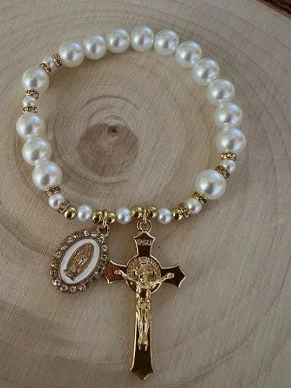 Close-up of Our Lady of Guadalupe rosary bracelet with crystal pearls and detailed gold crucifix charm