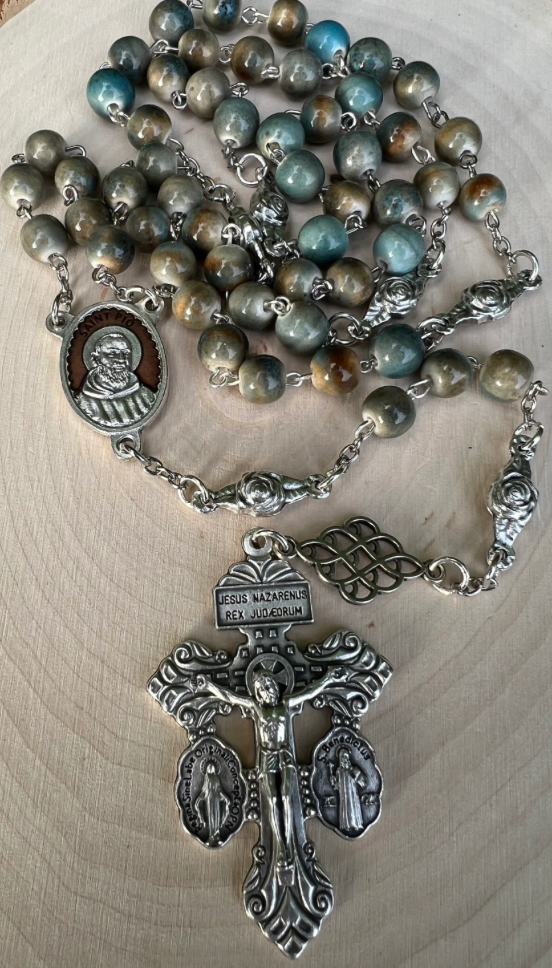 Catholic Padre Pio rosary with glazed ceramic beads, Saint Pio centerpiece, and detailed Pardon Crucifix, handcrafted for prayer and devotion.