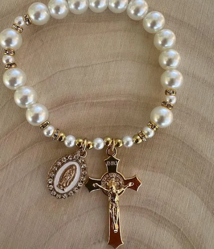 Stretch rosary bracelet with white pearls, gold rhinestone spacers, and devotional crucifix charm for daily Catholic prayer