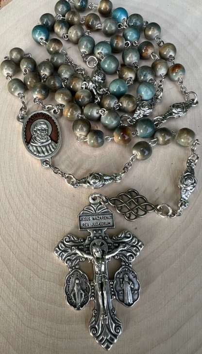 Catholic Padre Pio rosary with glazed ceramic beads, Saint Pio centerpiece, and detailed Pardon Crucifix, handcrafted for prayer and devotion.
